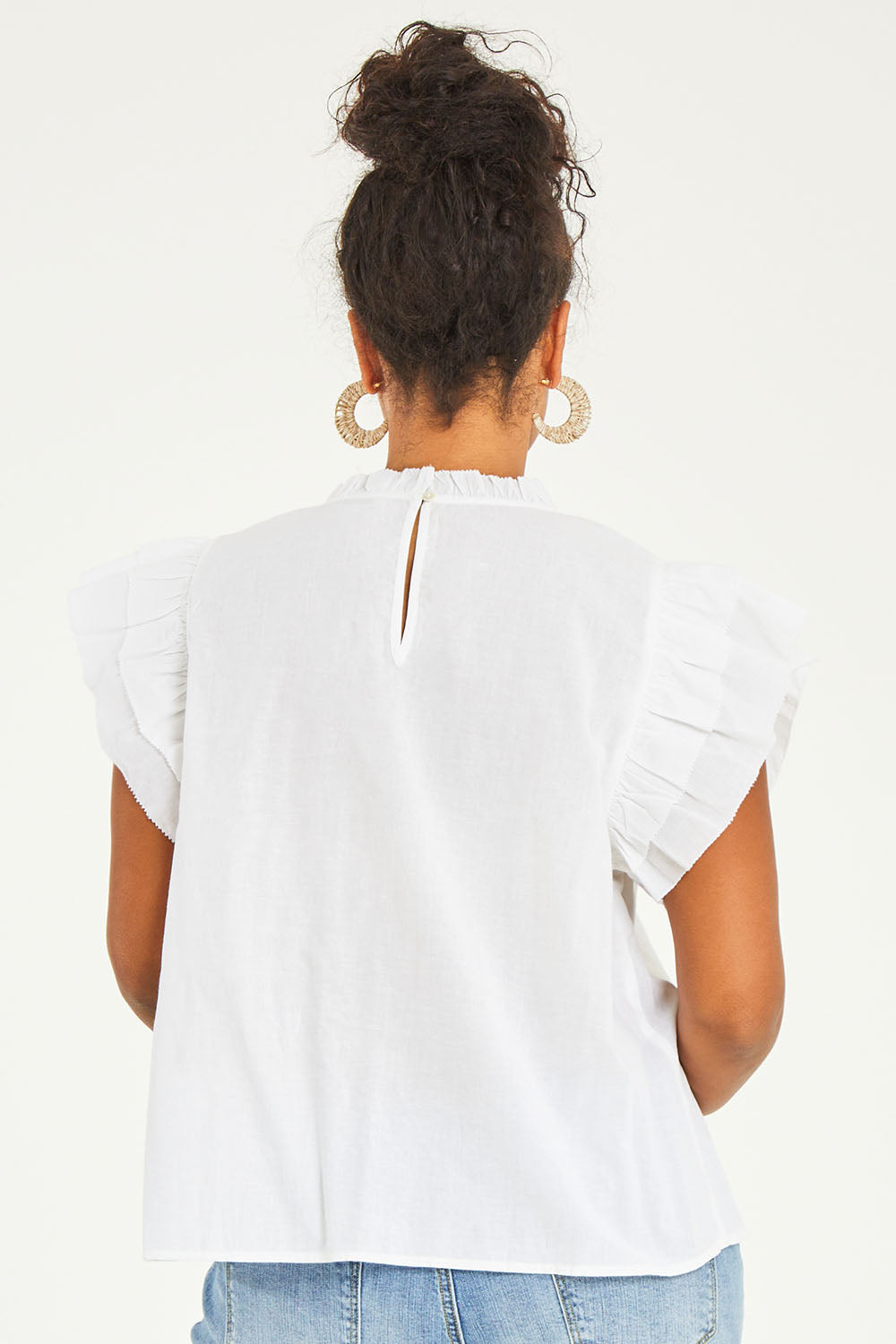 Model Noli wearing size 14 of the Feel Good Friday Blouse in colour Milk (White), from the back