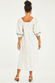 Model Noli wearing size 14 of the Picnic In The Fields Embroidered Dress in colour Milk (White), from the back