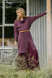 Model Tegan wearing size 10 of the Cross My Heart Tunic in colour Wine (Purple), from the front, showing the whole outfit
