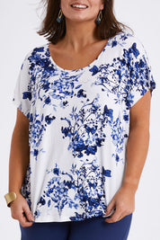 Model Monique wearing size 14 of the Falling Flowers Tee in colour Bluewhite (Blue), from the front, cropped image