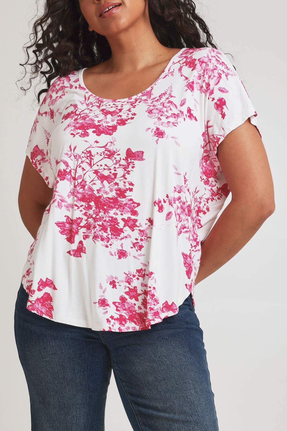 Model Terri-Leigh wearing size 14 of the Falling Flowers Tee in colour Pinkwhite (Pink), from the front, cropped image