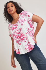 Model Terri-Leigh wearing size 14 of the Falling Flowers Tee in colour Pinkwhite (Pink), from the front, cropped image