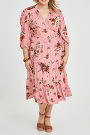Model Keeara wearing size 16 of the Pocket Full Of Dreams Wrap Dress in colour Hibiscus (Pink), from the front, cropped image