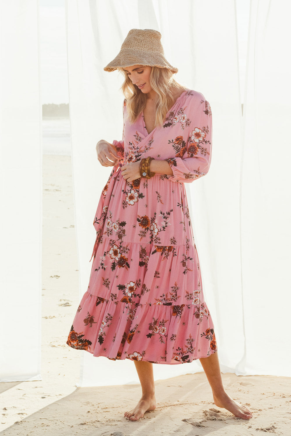 Model Tegan wearing size 10 of the Pocket Full Of Dreams Wrap Dress in colour Hibiscus (Pink), from the front, showing the whole outfit
