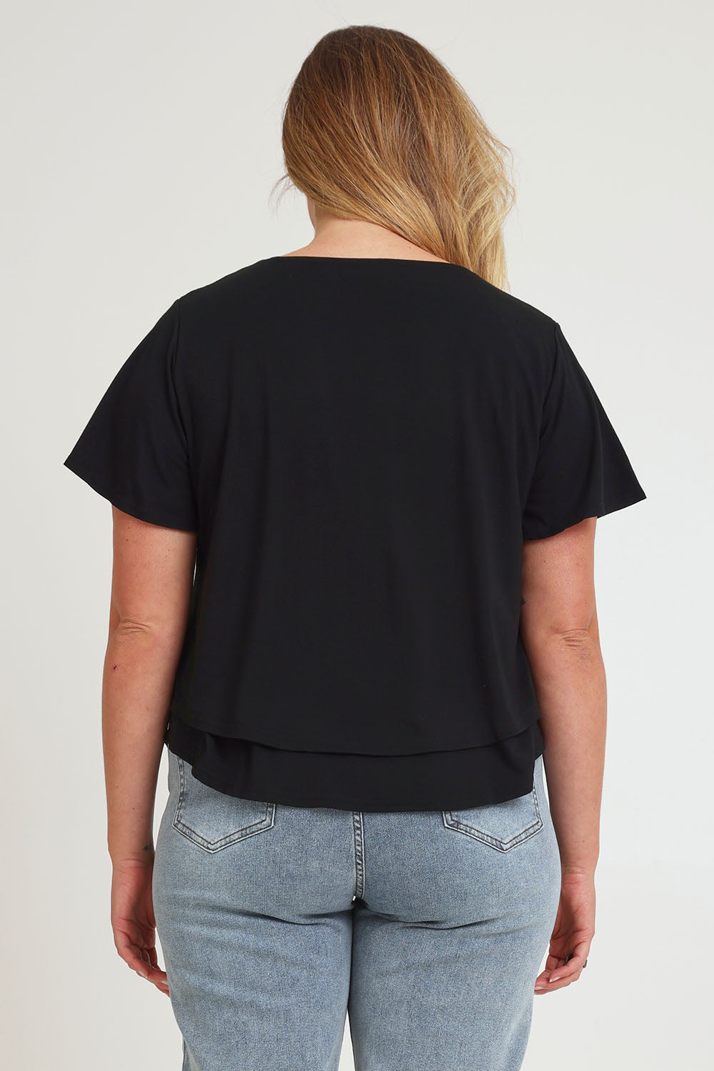 Model Chanel wearing size 16 of the Short And Sweet Bamboo Layered Tee in colour Black (Black), from the back