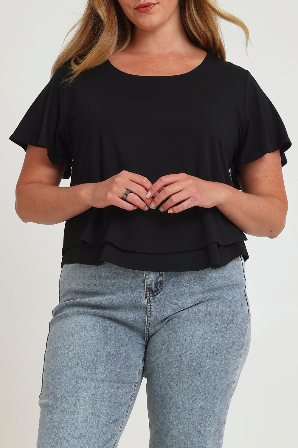 Model Chanel wearing size 16 of the Short And Sweet Bamboo Layered Tee in colour Black (Black), from the front, cropped image