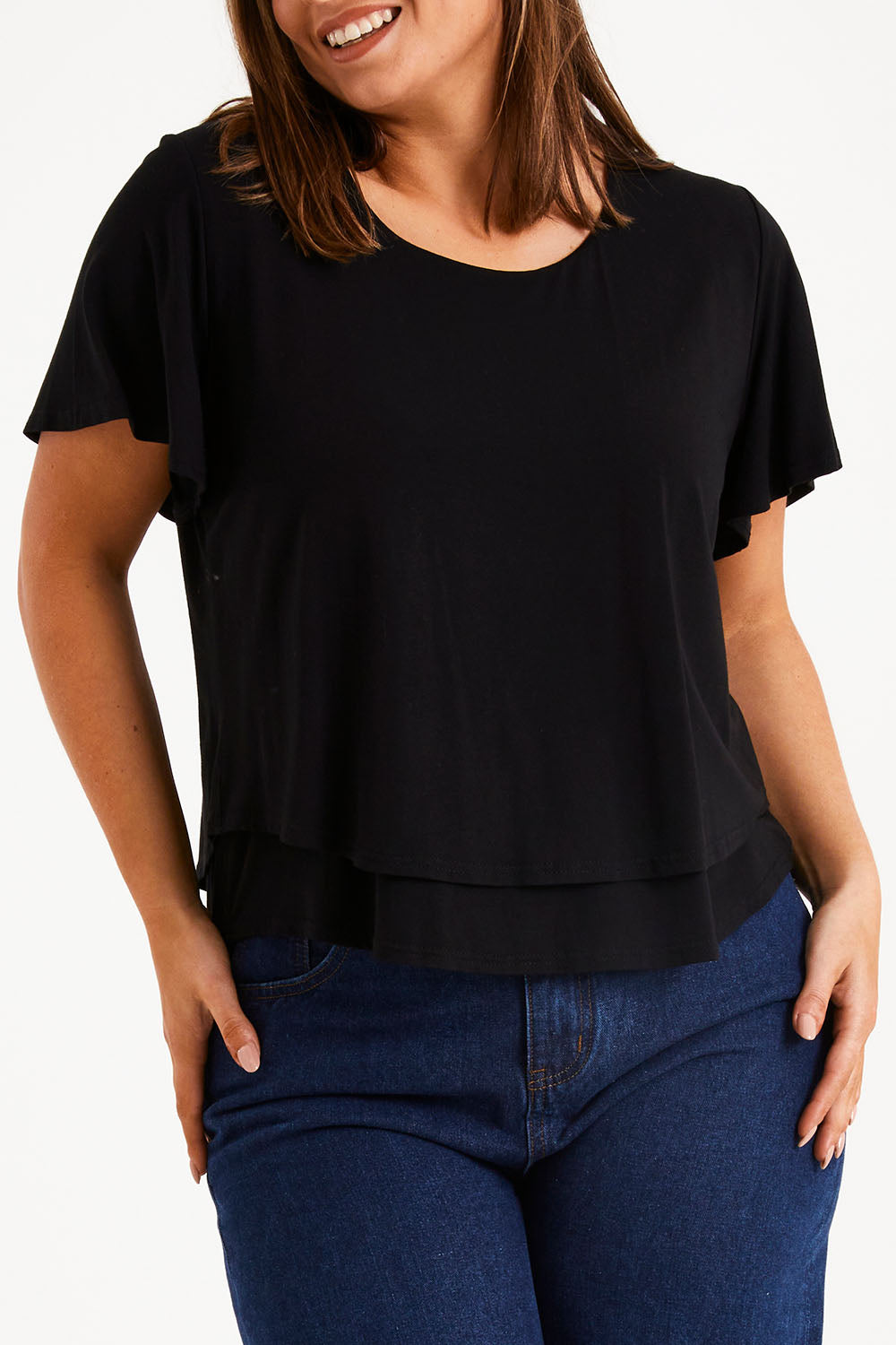 Model Monique wearing size 14 of the Short And Sweet Bamboo Layered Tee in colour Black (Black), from the front, cropped image