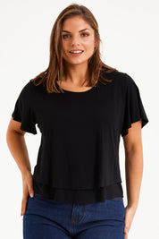 Model Monique wearing size 14 of the Short And Sweet Bamboo Layered Tee in colour Black (Black), from the front, cropped image