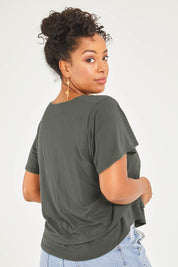 Model Noli wearing size 14 of the Short And Sweet Bamboo Layered Tee in colour Combat (Green), from the back