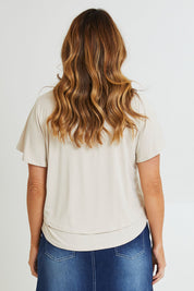 Model Laura wearing size 14 of the Short And Sweet Bamboo Layered Tee in colour Natural, from the back