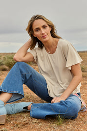 Model Tegan wearing size 10 of the Short And Sweet Bamboo Layered Tee in colour Natural, from the front, showing the whole outfit