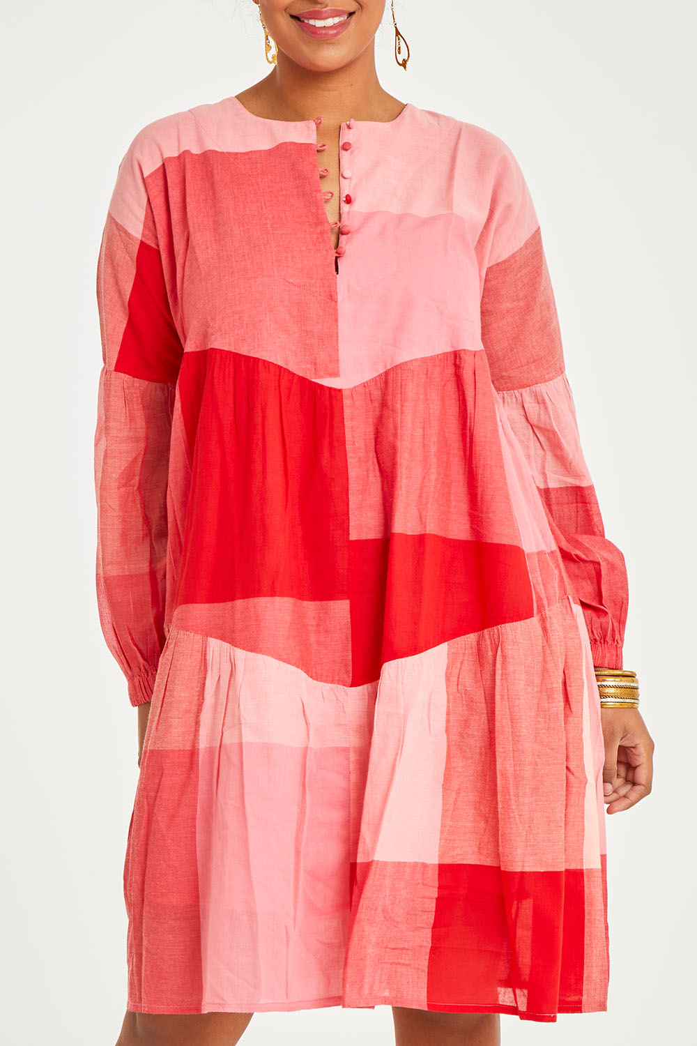 Model Noli wearing size 14 of the Twirl Worthy Cotton Tiered Dress in colour Redpink (Pink), from the front, cropped image