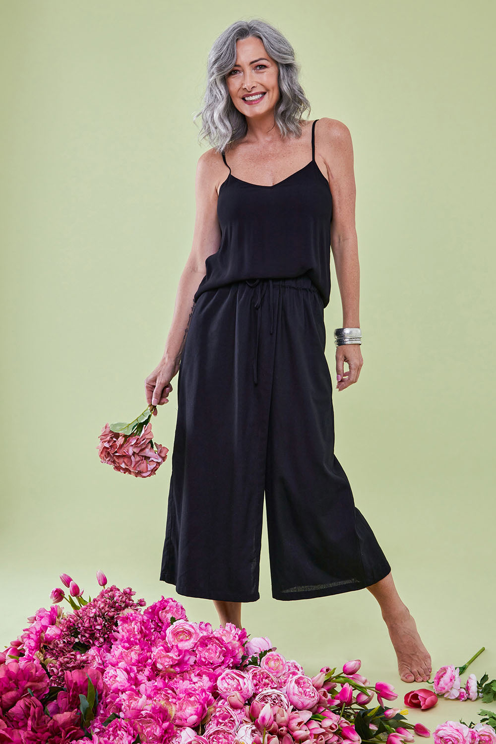 Model Luisa wearing size 10 of the Thats A Wrap Front Pants in colour Black (Black), from the front, showing the whole outfit