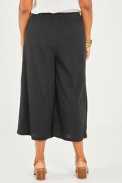 Model Noli wearing size 14 of the Thats A Wrap Front Pants in colour Black (Black), from the back