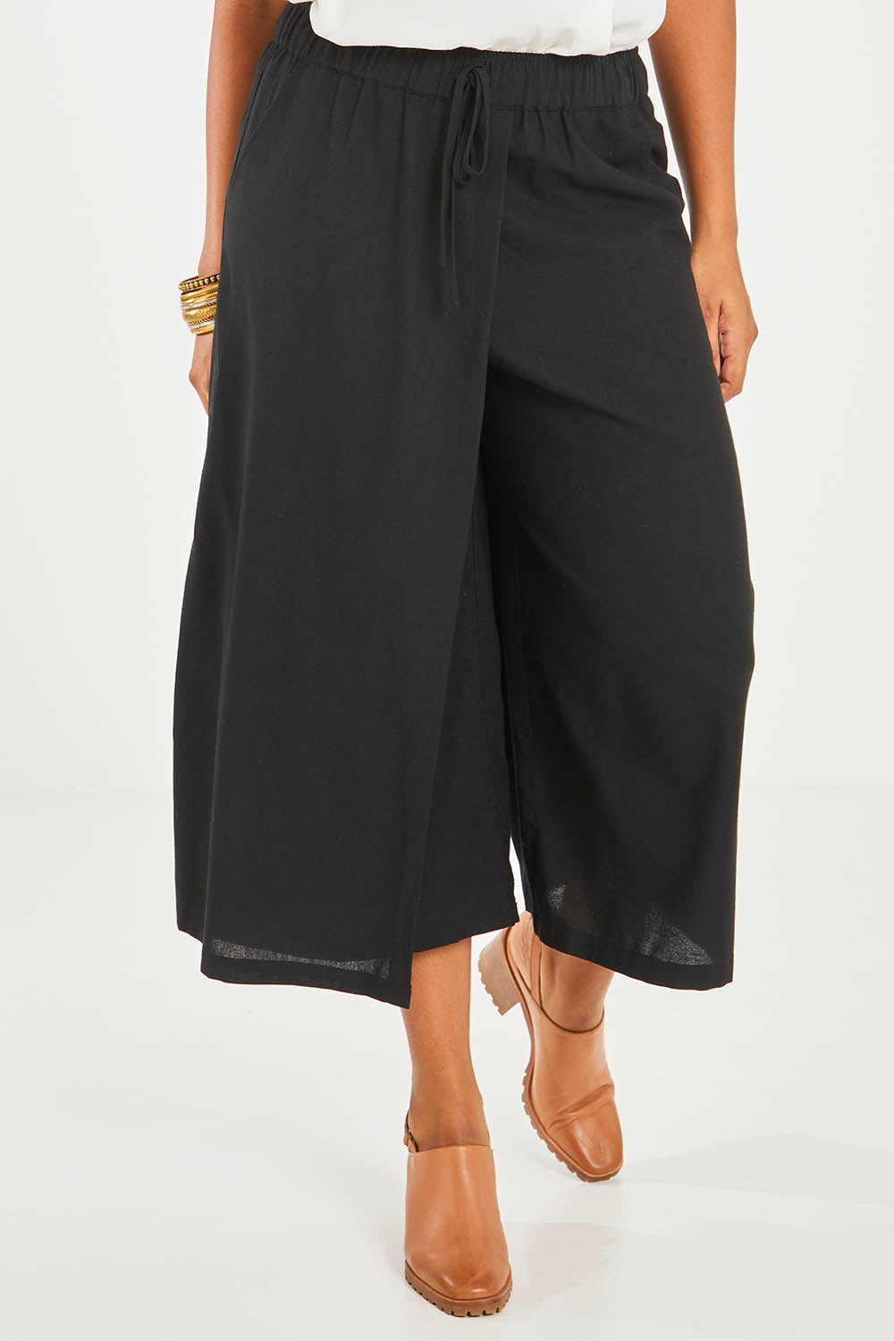 Model Noli wearing size 14 of the Thats A Wrap Front Pants in colour Black (Black), from the front, cropped image