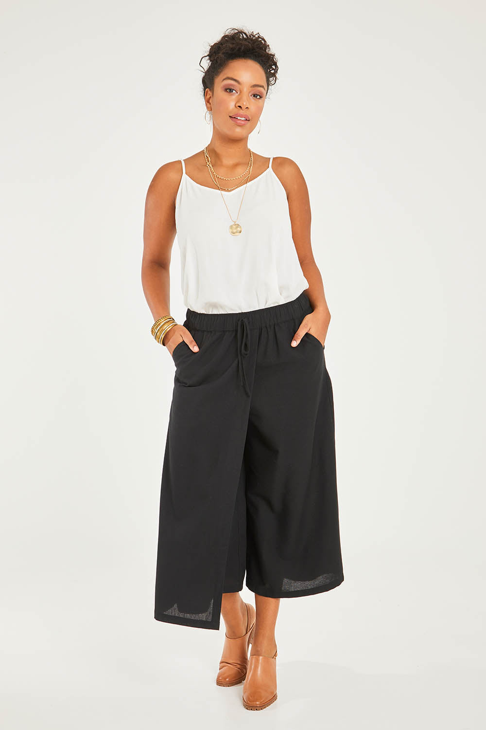 Model Noli wearing size 14 of the Thats A Wrap Front Pants in colour Black (Black), from the front, showing the whole outfit