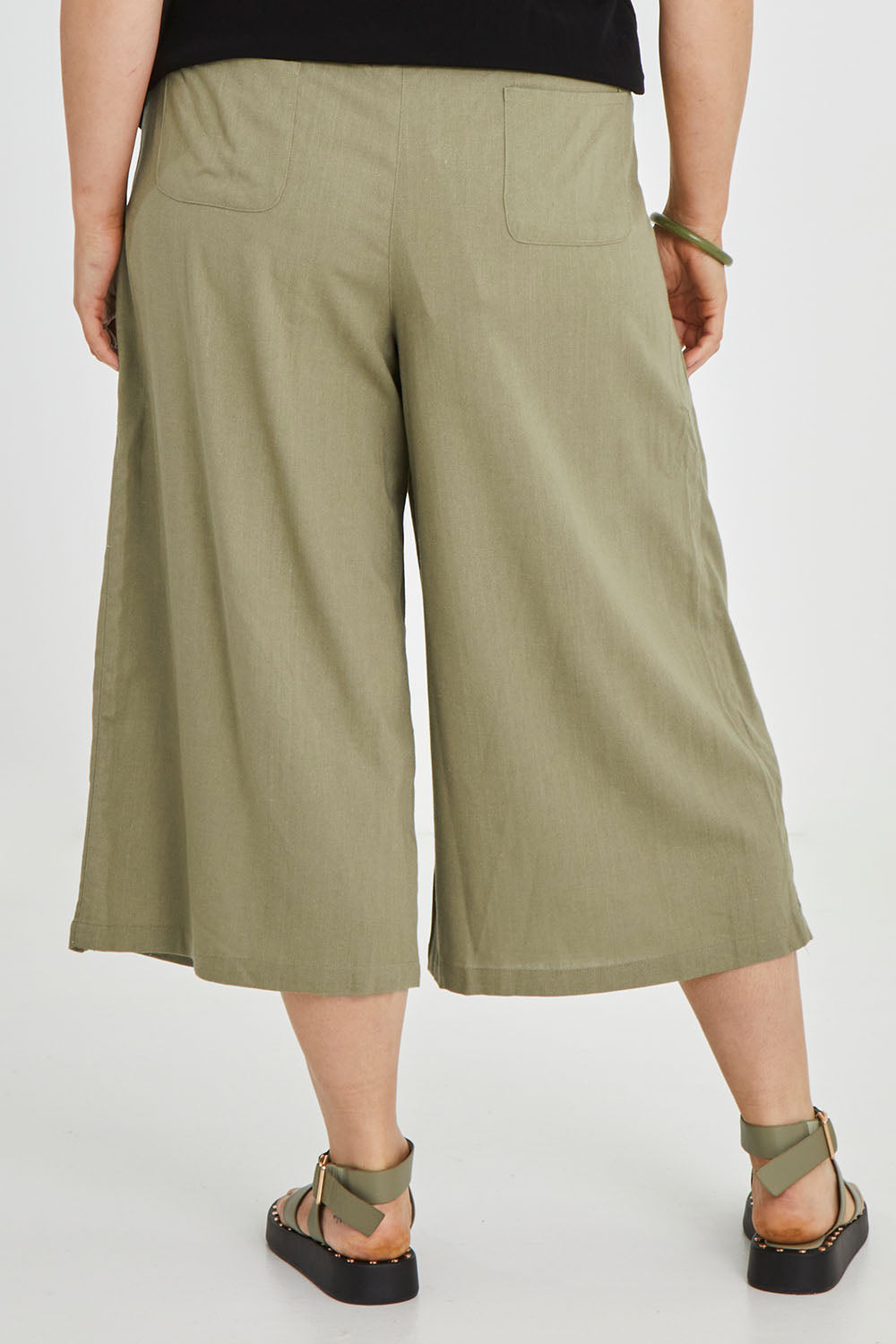 Model Keeara wearing size 16 of the Thats A Wrap Front Pants in colour Khaki (Green), from the back