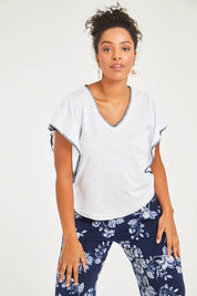 Model Noli wearing size 14 of the Blanket Stitch Butterfly Top in colour White (White), from the front, cropped image