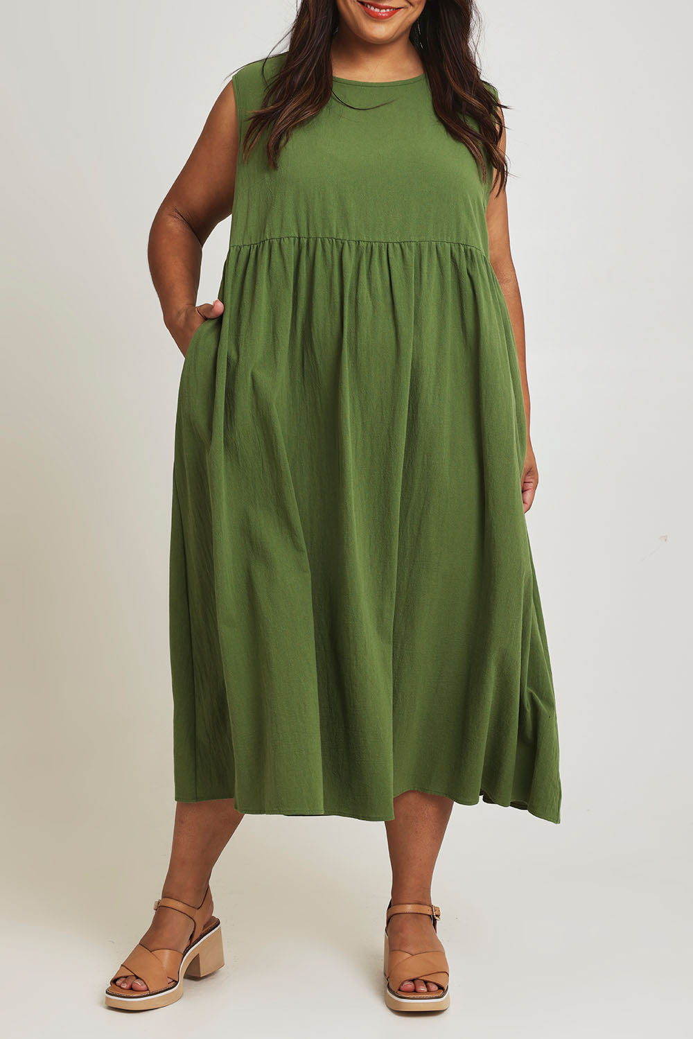 Model Ashleigh wearing size 16 of the A Cloudless Day Dress in colour Fern (Green), from the front, cropped image