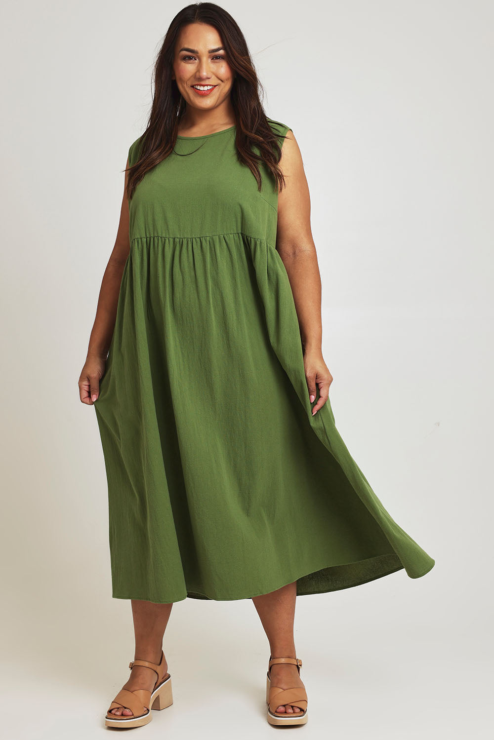 Model Ashleigh wearing size 16 of the A Cloudless Day Dress in colour Fern (Green), from the front, showing the whole outfit