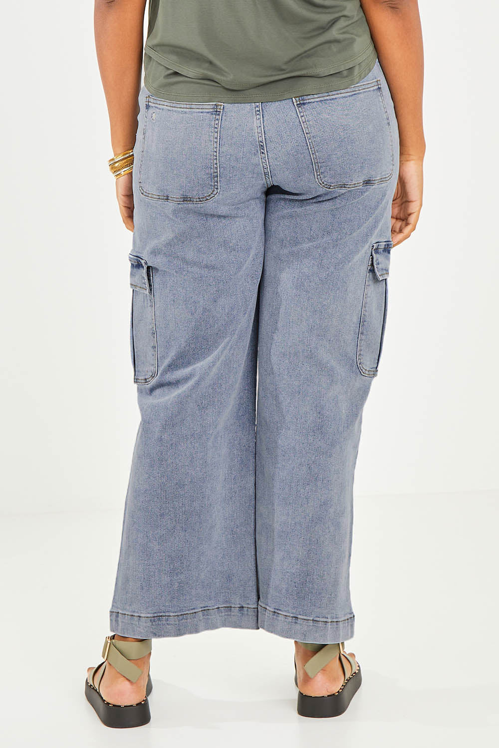 Model Noli wearing size 14 of the Chasing After You Cargo Jeans in colour Denim (Blue), from the back