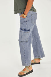 Model Noli wearing size 14 of the Chasing After You Cargo Jeans in colour Denim (Blue), from the front, cropped image