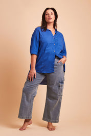 Model Poppy wearing size 16 of the Chasing After You Cargo Jeans in colour Denim (Blue), from the front, showing the whole outfit