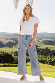Model Tegan wearing size 10 of the Chasing After You Cargo Jeans in colour Denim (Blue), from the front, showing the whole outfit
