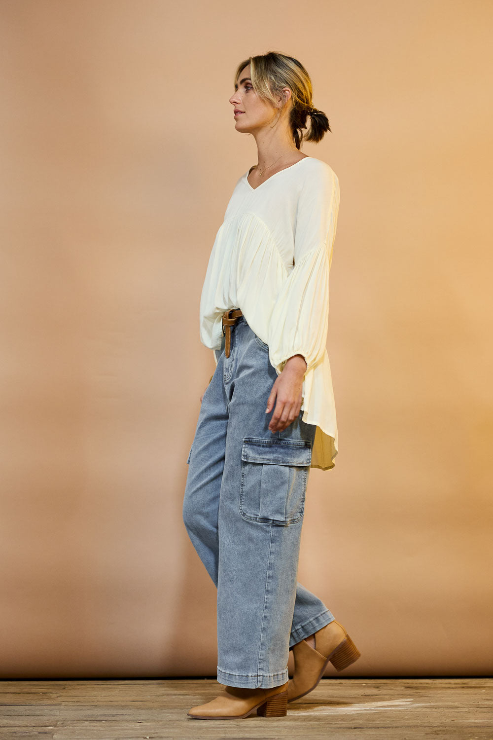 Model Tegan wearing size 10 of the Chasing After You Cargo Jeans in colour Denim (Blue), from the front, showing the whole outfit