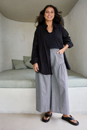 Model Tahnee wearing size 10 of the Relaxed Elegance Boyfriend Shirt in colour Black (Black), from the front, showing the whole outfit
