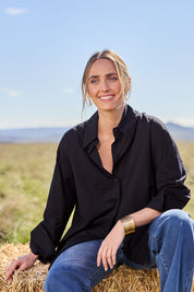Model Tegan wearing size 10 of the Relaxed Elegance Boyfriend Shirt in colour Black (Black), from the front, showing the whole outfit