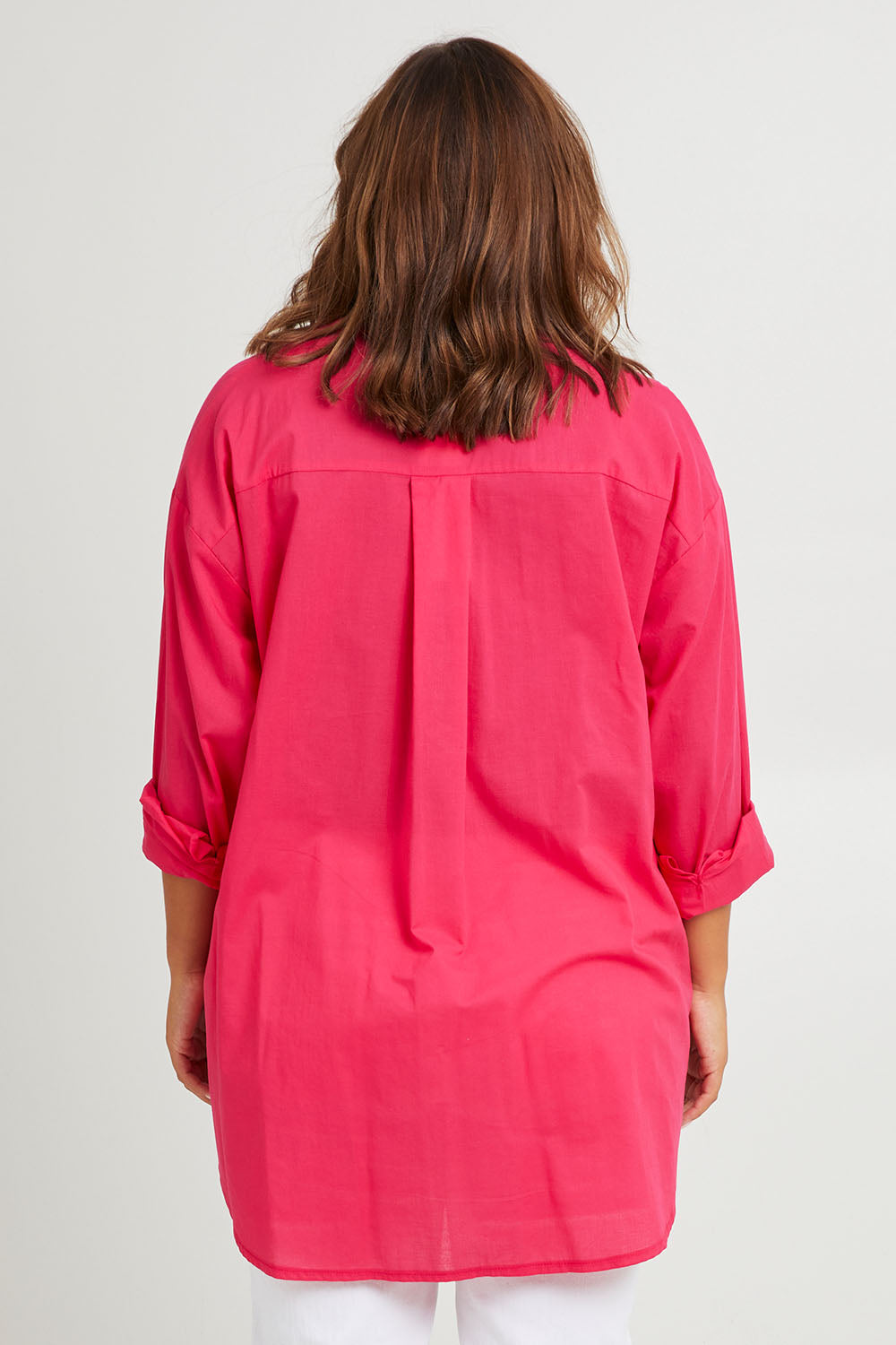 Model Monique wearing size 14 of the Relaxed Elegance Boyfriend Shirt in colour Hotpink (Pink), from the back