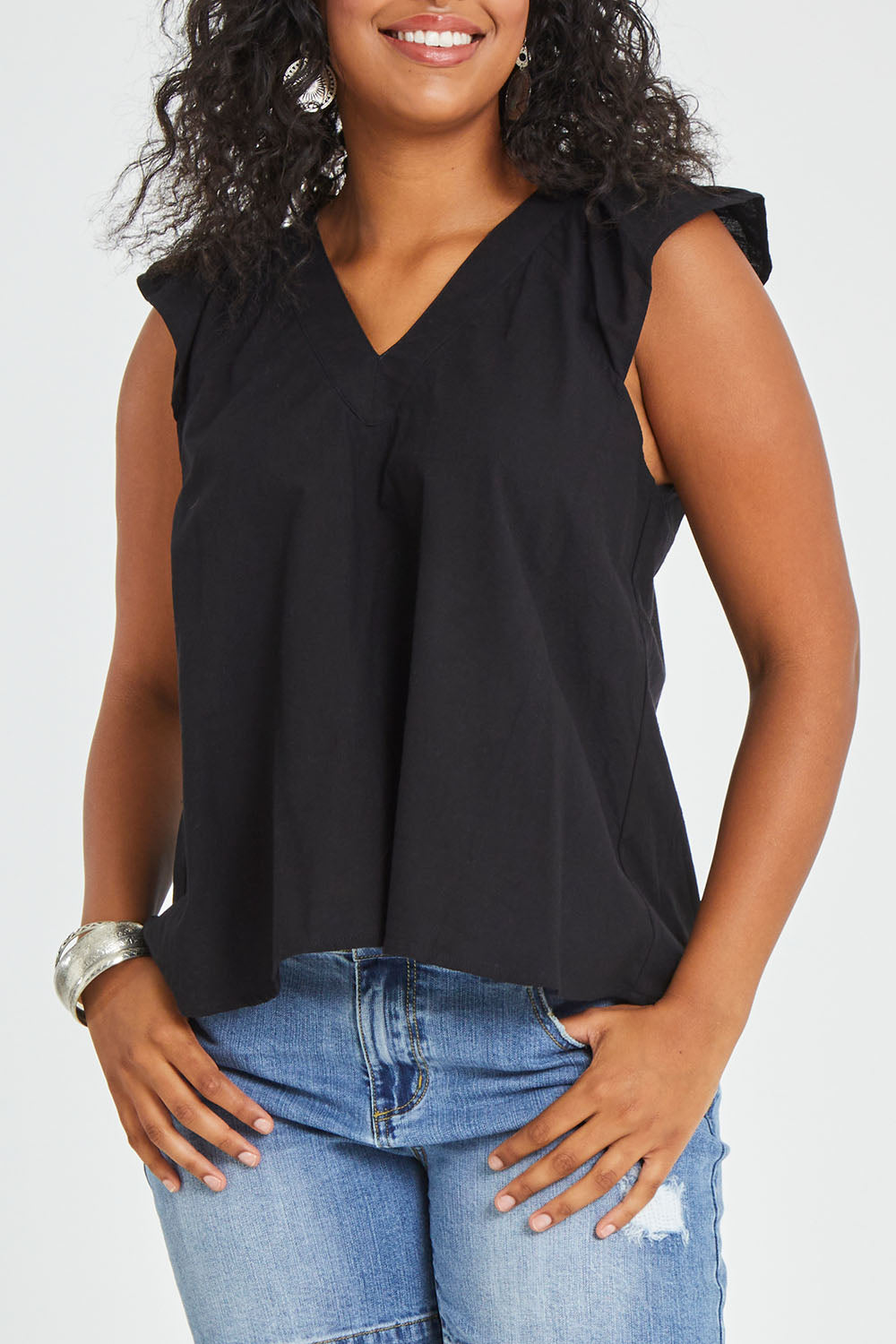 Model Noli wearing size 14 of the Frill Me Cotton Top in colour Black (Black), from the front, cropped image