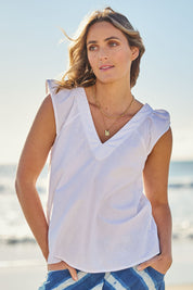 Model Tegan wearing size 10 of the Frill Me Cotton Top in colour White (White), from the front, showing the whole outfit