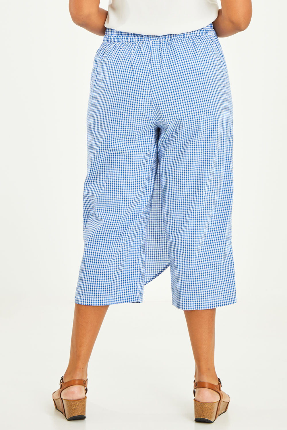 Model Noli wearing size 14 of the Honeypie Cotton Overlay Pants in colour Blue (Blue), from the back