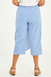 Model Noli wearing size 14 of the Honeypie Cotton Overlay Pants in colour Blue (Blue), from the back