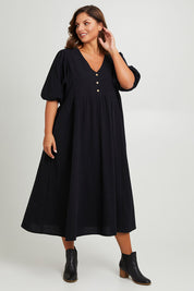 Model Monique wearing size 14 of the Summer Picnic Smock Dress in colour Black (Black), from the front, showing the whole outfit