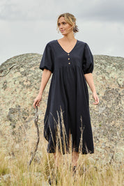 Model Tegan wearing size 10 of the Summer Picnic Smock Dress in colour Black (Black), from the front, showing the whole outfit