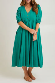 Model Laura wearing size 14 of the Summer Picnic Smock Dress in colour Springreen (Green), from the front, cropped image