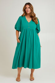 Model Laura wearing size 14 of the Summer Picnic Smock Dress in colour Springreen (Green), from the front, showing the whole outfit