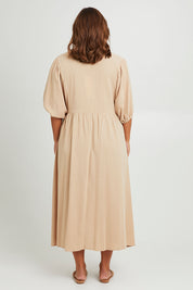 Model Monique wearing size 14 of the Summer Picnic Smock Dress in colour Stone, from the back