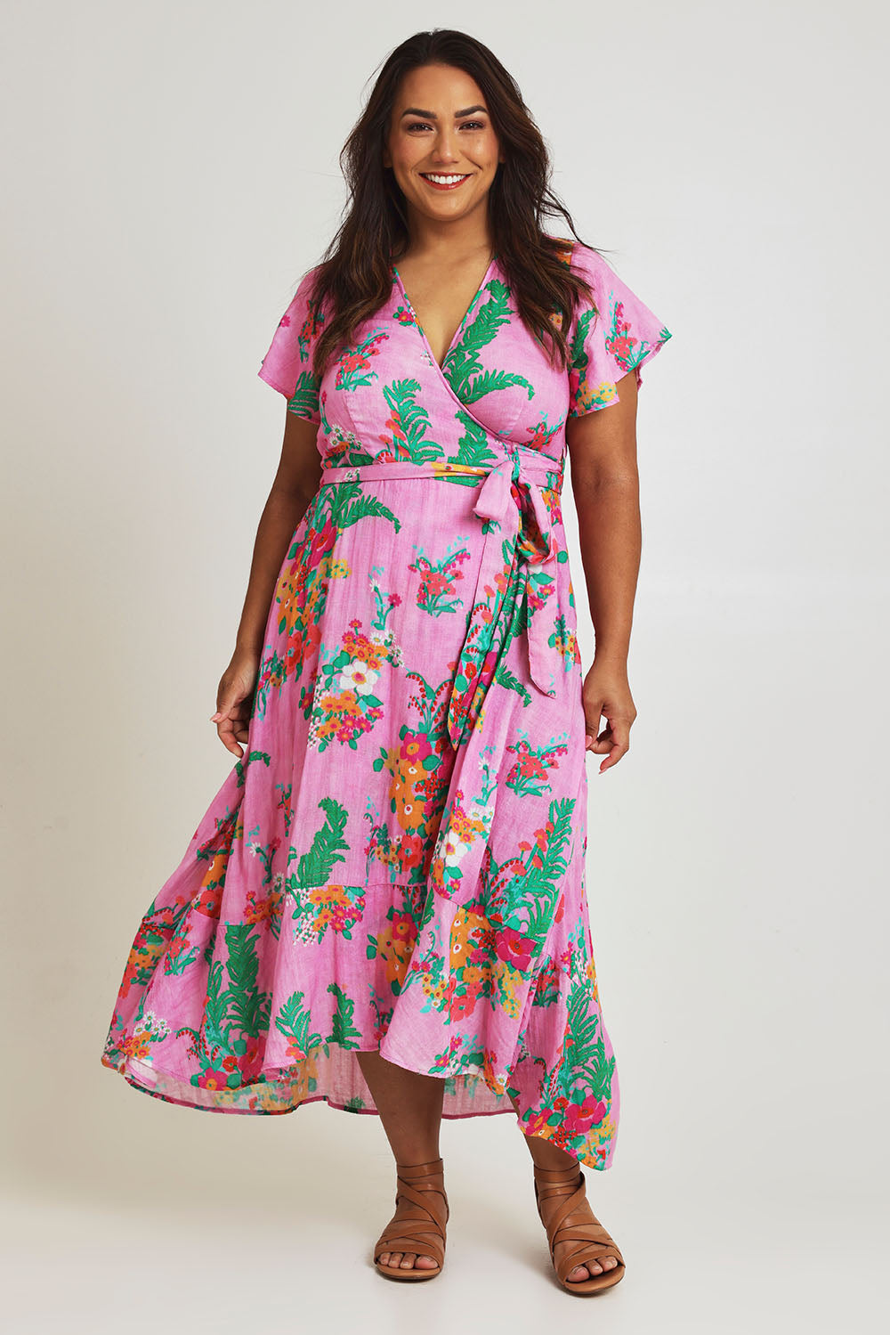 Model Ashleigh wearing size 16 of the Thats A Wrap Printed Cotton Dress in colour Pinkgarden (Pink), from the front, showing the whole outfit