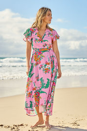 Model Tegan wearing size 10 of the Thats A Wrap Printed Cotton Dress in colour Pinkgarden (Pink), from the front, showing the whole outfit