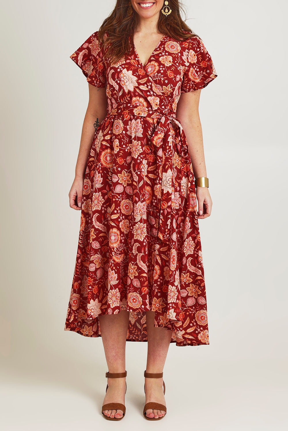 Model Jane wearing size 14 of the Thats A Wrap Printed Cotton Dress in colour Clayfleur, from the front, cropped image
