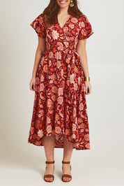 Model Jane wearing size 14 of the Thats A Wrap Printed Cotton Dress in colour Clayfleur, from the front, cropped image
