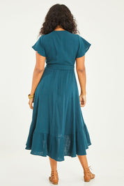 Model Noli wearing size 14 of the Thats A Wrap Organic Cotton Dress in colour Lagoon (Blue), from the back