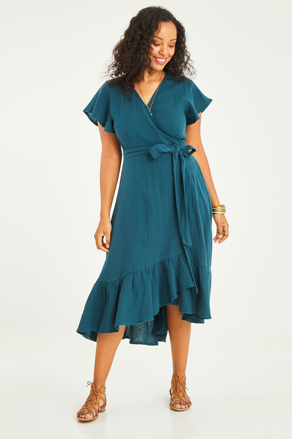 Model Noli wearing size 14 of the Thats A Wrap Organic Cotton Dress in colour Lagoon (Blue), from the front, showing the whole outfit