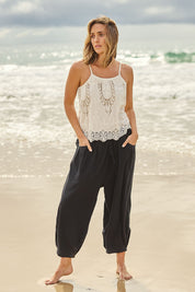 Model Tegan wearing size 10 of the Beach Stroll Cotton Pants in colour Black (Black), from the front, showing the whole outfit