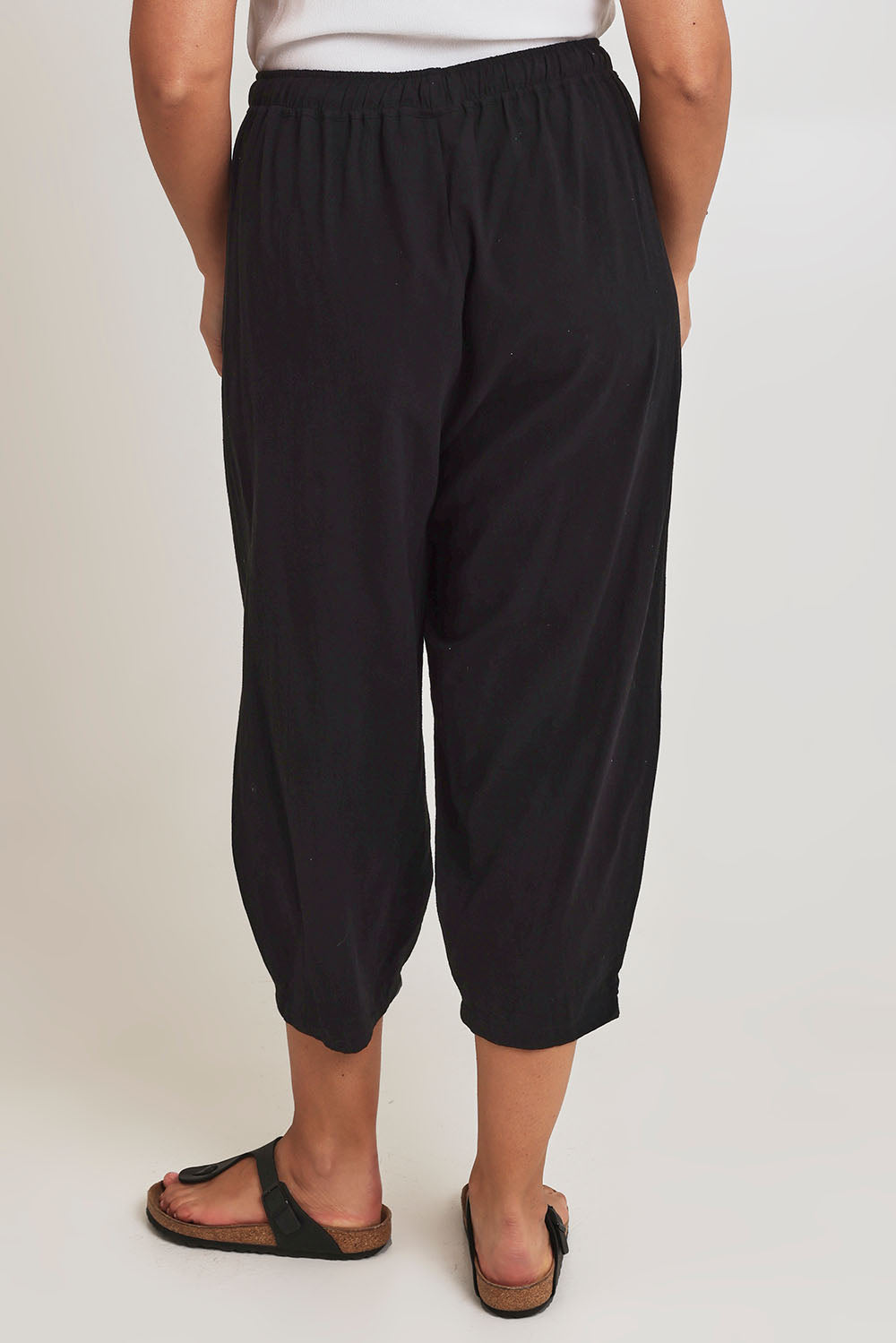 Model Terri-Leigh wearing size 14 of the Beach Stroll Cotton Pants in colour Black (Black), from the back