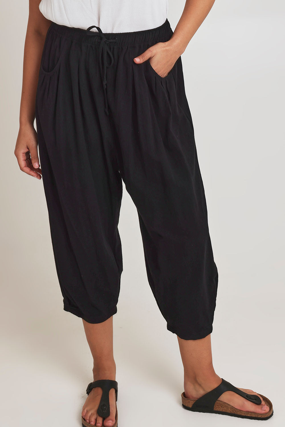 Model Terri-Leigh wearing size 14 of the Beach Stroll Cotton Pants in colour Black (Black), from the front, cropped image